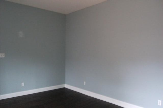12615 Dove Valley Trl, Austin, TX 78729 - empty room featuring baseboards and dark wood-style floors