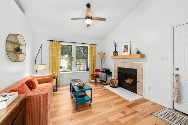 11901 Swearingen Dr Unit 43-I, Austin, TX 78758 - living room featuring vaulted ceiling, light wood-style flooring, ceiling fan, and a fireplace