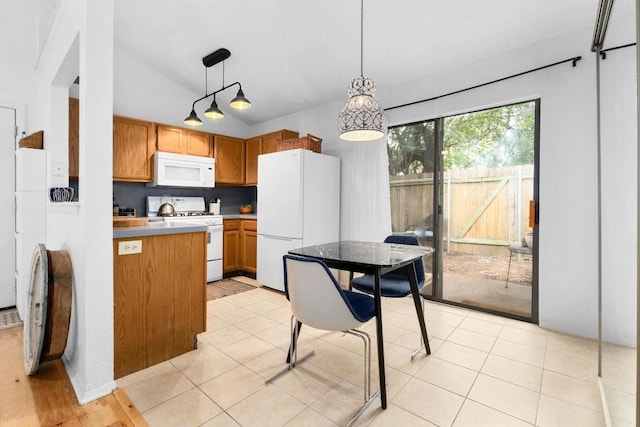 11901 Swearingen Dr Unit 43-I, Austin, TX 78758 - kitchen with white appliances, decorative light fixtures, vaulted ceiling, brown cabinetry, and light countertops