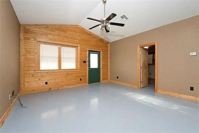 4901 County Road 210, Bertram, TX 78605 - unfurnished room featuring wood walls, concrete flooring, lofted ceiling, and ceiling fan