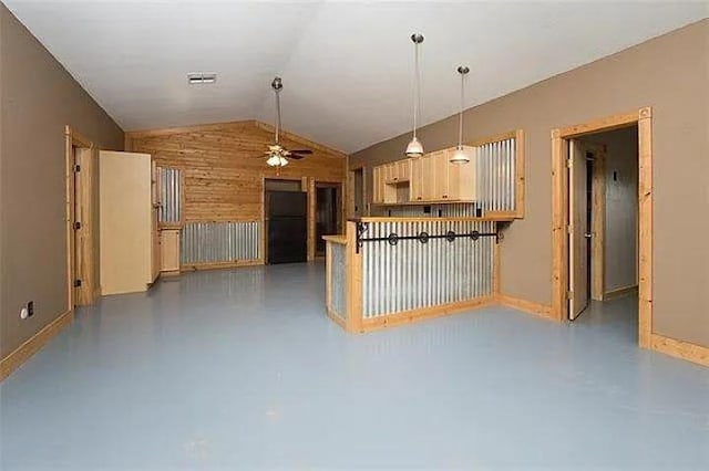 4901 County Road 210, Bertram, TX 78605 - kitchen featuring a ceiling fan, lofted ceiling, wooden walls, finished concrete floors, and decorative light fixtures