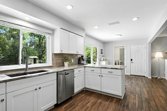 7314 Danwood Dr, Austin, TX 78759 - kitchen featuring stainless steel dishwasher, a peninsula, light stone counters, dark wood finished floors, and recessed lighting