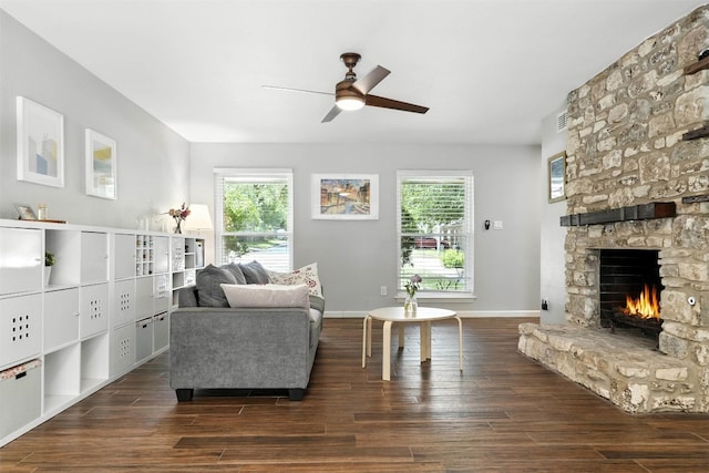 7314 Danwood Dr, Austin, TX 78759 - living room featuring a stone fireplace, dark wood finished floors, and ceiling fan
