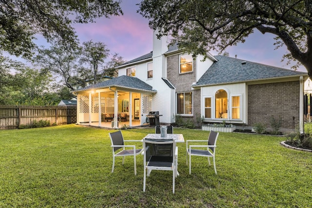 1104 Woodhollow Ln, Cedar Park, TX 78613 - back of house with a patio, a shingled roof, and brick siding
