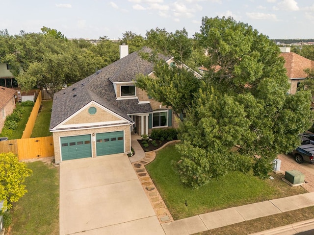 1104 Woodhollow Ln, Cedar Park, TX 78613 - view of front of house featuring roof with shingles, an attached garage, concrete driveway, brick siding, and a chimney
