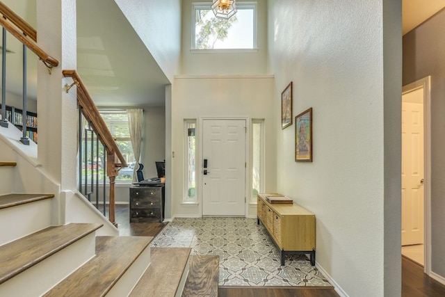 1104 Woodhollow Ln, Cedar Park, TX 78613 - entryway with stairs, a high ceiling, healthy amount of natural light, and wood finished floors