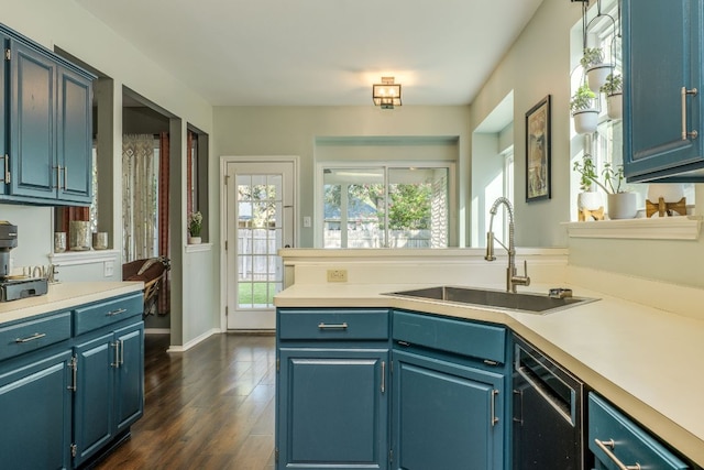 1104 Woodhollow Ln, Cedar Park, TX 78613 - kitchen with light countertops, dark wood finished floors, and blue cabinetry