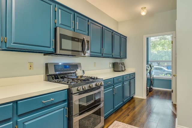 1104 Woodhollow Ln, Cedar Park, TX 78613 - kitchen with stainless steel appliances, light countertops, dark wood-style flooring, and blue cabinetry