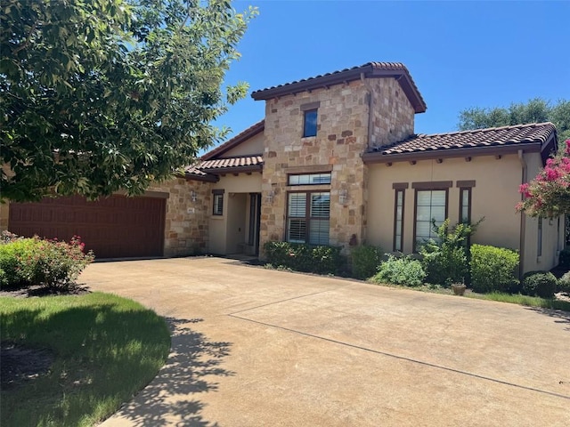 404 Amiata Ave Unit 34, Austin, TX 78734 - mediterranean / spanish house with a tile roof, stone siding, concrete driveway, and stucco siding
