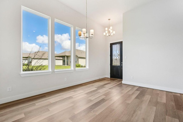 181 Benedum Way, Liberty Hill, TX 78642 - unfurnished dining area with a chandelier and wood finished floors