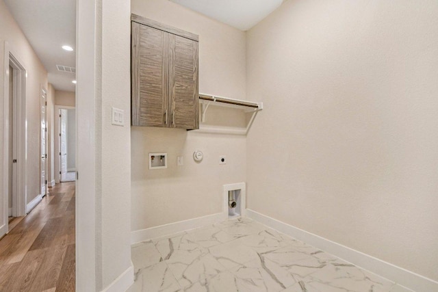181 Benedum Way, Liberty Hill, TX 78642 - laundry room with electric dryer hookup, hookup for a gas dryer, hookup for a washing machine, recessed lighting, and light marble finish floors