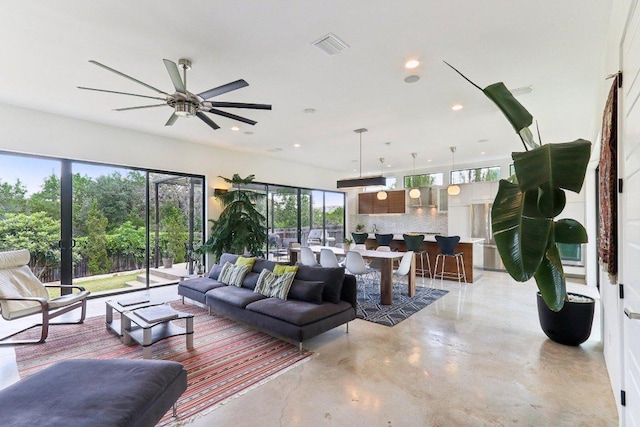 13008 Medina River Way, Austin, TX 78732 - living area with concrete floors, ceiling fan, and recessed lighting