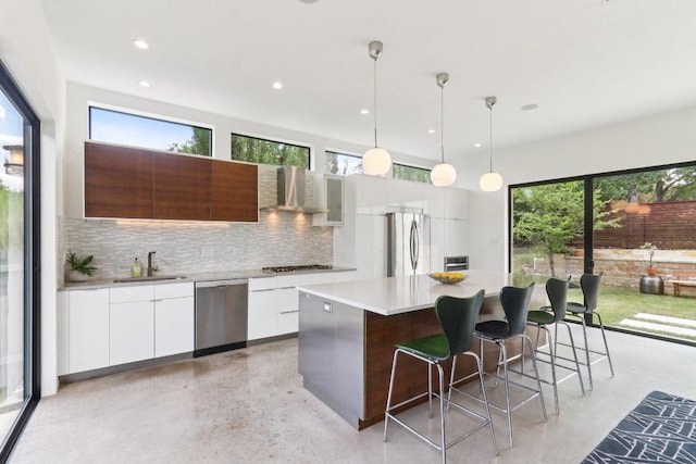 13008 Medina River Way, Austin, TX 78732 - kitchen featuring modern cabinets, backsplash, a kitchen island, a breakfast bar, and recessed lighting