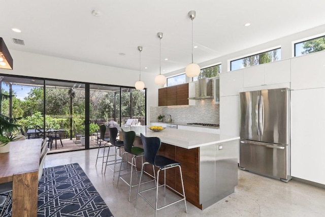 13008 Medina River Way, Austin, TX 78732 - kitchen with freestanding refrigerator, light countertops, plenty of natural light, tasteful backsplash, and recessed lighting