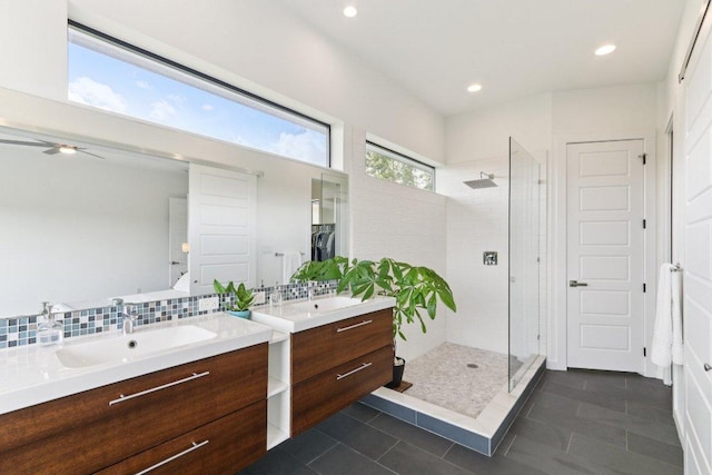 13008 Medina River Way, Austin, TX 78732 - bathroom featuring a stall shower, two vanities, tile patterned floors, ceiling fan, and recessed lighting
