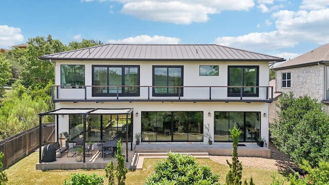 13008 Medina River Way, Austin, TX 78732 - rear view of house featuring a standing seam roof, a patio area, a metal roof, and stucco siding