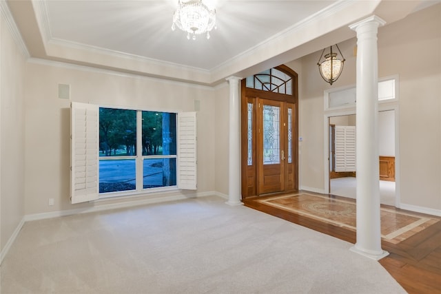 24205 State Highway 71 W, Spicewood, TX 78669 - foyer entrance with decorative columns, ornamental molding, a chandelier, carpet floors, and wood finished floors