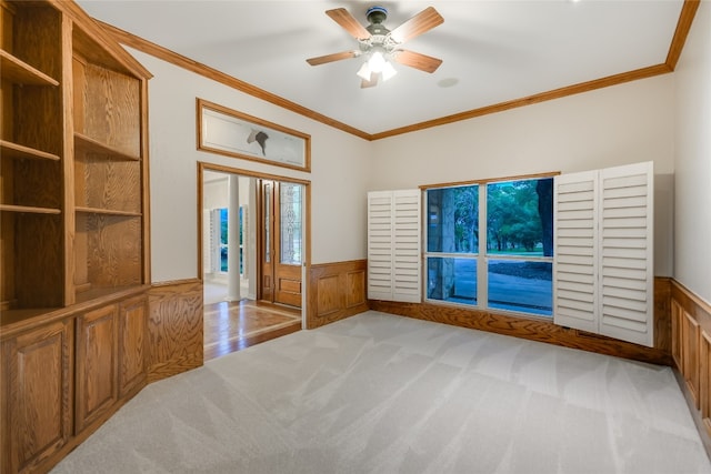 24205 State Highway 71 W, Spicewood, TX 78669 - empty room featuring carpet flooring, crown molding, a wainscoted wall, and ceiling fan