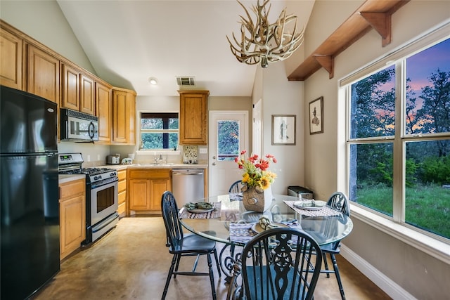 24205 State Highway 71 W, Spicewood, TX 78669 - kitchen featuring stainless steel appliances, a chandelier, light countertops, lofted ceiling, and concrete flooring