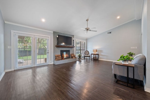 4310 Ponderosa Ln, Temple, TX 76502 - living area featuring a fireplace, a ceiling fan, lofted ceiling, crown molding, and dark wood-style flooring
