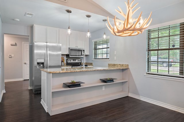 4310 Ponderosa Ln, Temple, TX 76502 - kitchen with a peninsula, stainless steel appliances, white cabinets, dark wood-style floors, and lofted ceiling