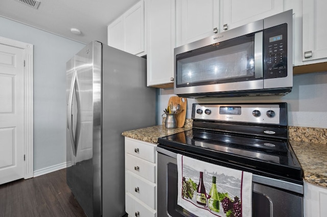 4310 Ponderosa Ln, Temple, TX 76502 - kitchen with stainless steel appliances, white cabinetry, dark wood-style flooring, and stone counters
