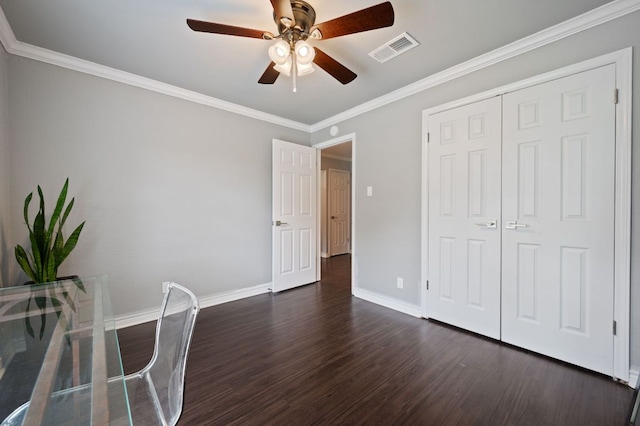 4310 Ponderosa Ln, Temple, TX 76502 - unfurnished bedroom with dark wood finished floors, ornamental molding, a closet, and a ceiling fan