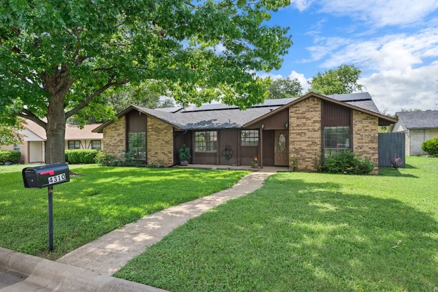 4310 Ponderosa Ln, Temple, TX 76502 - mid-century inspired home featuring brick siding, a front lawn, and roof mounted solar panels