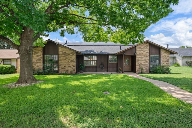4310 Ponderosa Ln, Temple, TX 76502 - mid-century modern home with brick siding, solar panels, and a front yard