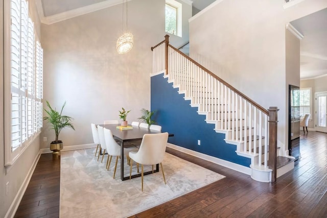 11612 Sierra Nevada, Austin, TX 78759 - dining room with hardwood / wood-style flooring, healthy amount of natural light, stairway, crown molding, and a high ceiling