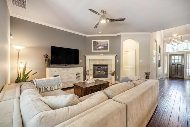 11612 Sierra Nevada, Austin, TX 78759 - living area featuring arched walkways, ceiling fan, crown molding, hardwood / wood-style floors, and a brick fireplace