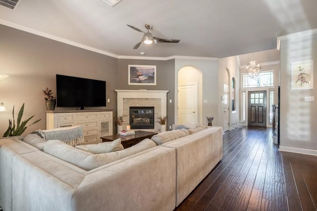11612 Sierra Nevada, Austin, TX 78759 - living area with arched walkways, ceiling fan, a chandelier, dark wood finished floors, and a fireplace