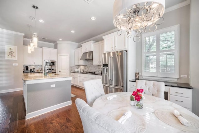 11612 Sierra Nevada, Austin, TX 78759 - kitchen with ornamental molding, a chandelier, appliances with stainless steel finishes, backsplash, and white cabinets