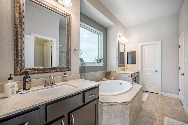 11612 Sierra Nevada, Austin, TX 78759 - full bath featuring a bath, two vanities, and tile patterned floors