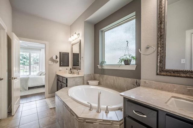 11612 Sierra Nevada, Austin, TX 78759 - ensuite bathroom with two vanities, a bath, and tile patterned floors