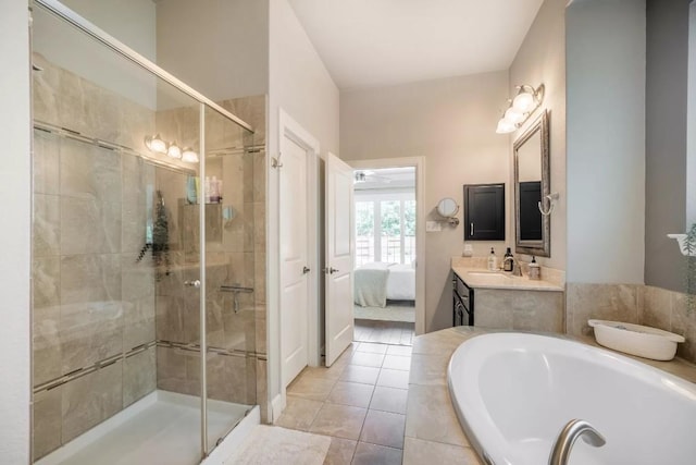 11612 Sierra Nevada, Austin, TX 78759 - ensuite bathroom featuring a bath, a shower stall, vanity, and tile patterned floors