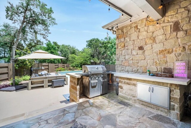 11612 Sierra Nevada, Austin, TX 78759 - fenced backyard featuring a patio area and exterior kitchen