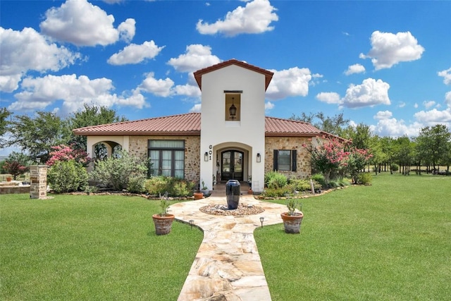 601 Strada Luca, Florence, TX 76527 - mediterranean / spanish-style home with french doors, a tile roof, a front yard, and stucco siding