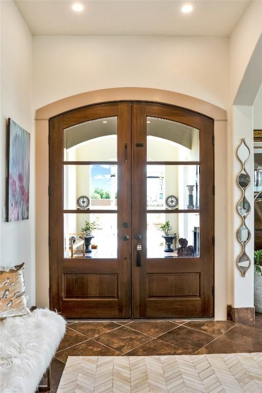 601 Strada Luca, Florence, TX 76527 - entryway with french doors, dark tile patterned flooring, arched walkways, and recessed lighting