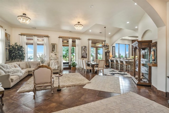 601 Strada Luca, Florence, TX 76527 - living room with a chandelier, arched walkways, and recessed lighting