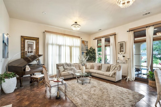 601 Strada Luca, Florence, TX 76527 - living room with a chandelier and dark tile patterned flooring
