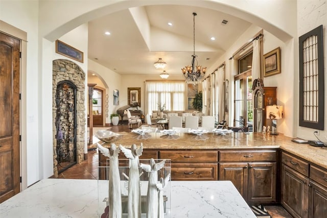 601 Strada Luca, Florence, TX 76527 - kitchen with open floor plan, light stone countertops, a chandelier, hanging light fixtures, and recessed lighting
