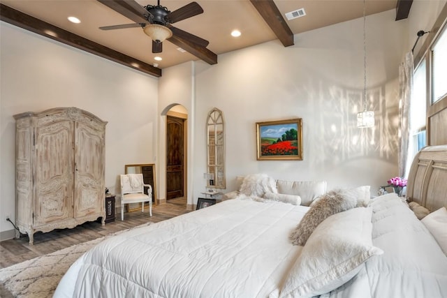601 Strada Luca, Florence, TX 76527 - bedroom featuring beam ceiling, arched walkways, wood finished floors, recessed lighting, and a high ceiling
