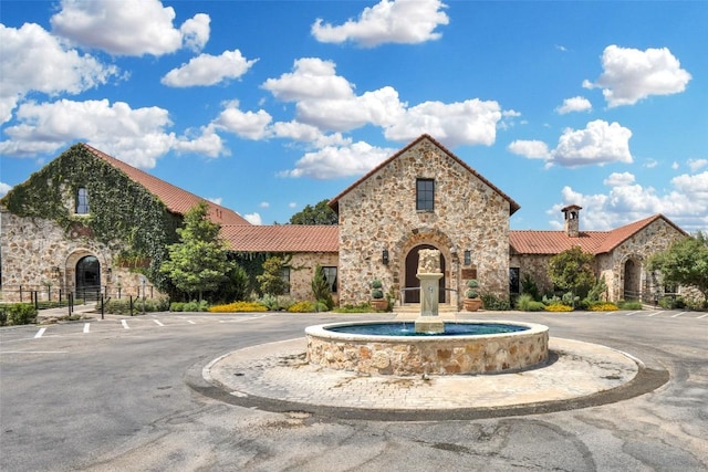 601 Strada Luca, Florence, TX 76527 - view of front facade featuring stone siding, uncovered parking, and a tile roof