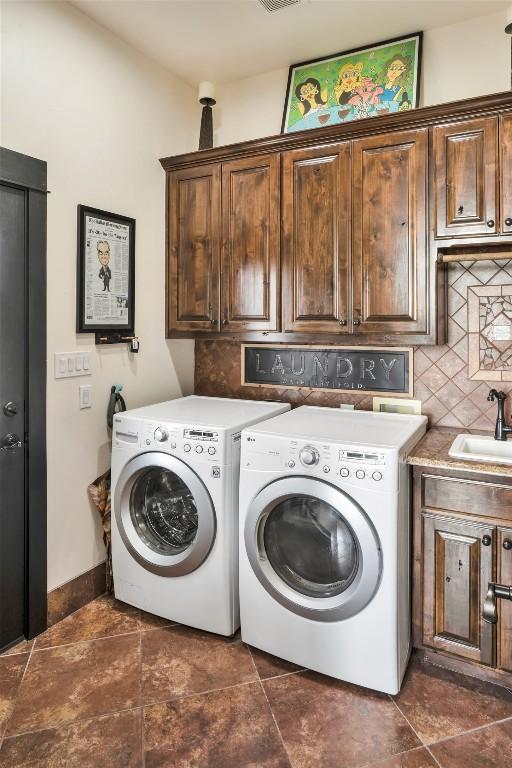 601 Strada Luca, Florence, TX 76527 - laundry area with cabinet space and washing machine and dryer