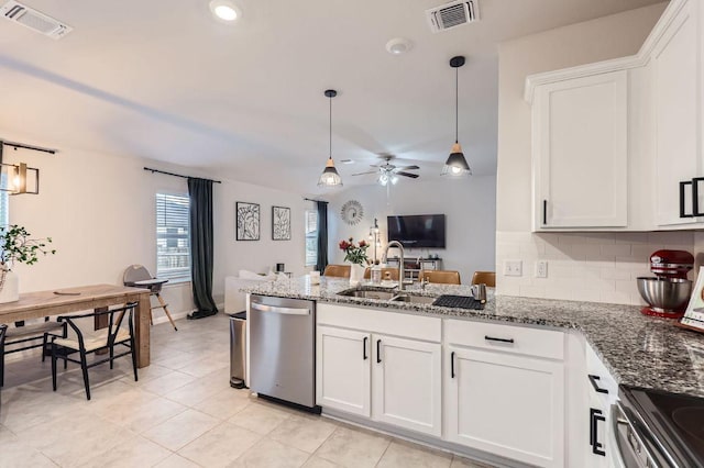 236 Cinnamon Loop, Burnet, TX 78611 - kitchen with a ceiling fan, a peninsula, appliances with stainless steel finishes, stone countertops, and white cabinetry