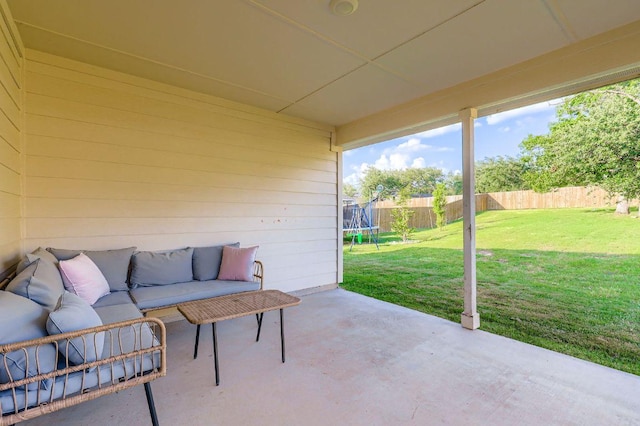 236 Cinnamon Loop, Burnet, TX 78611 - fenced backyard with a trampoline, a patio area, and an outdoor hangout area