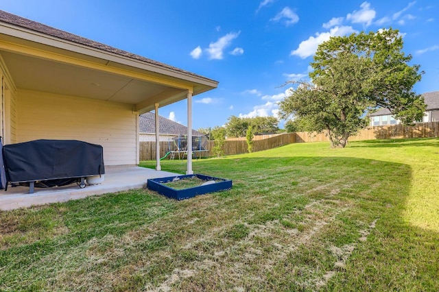 236 Cinnamon Loop, Burnet, TX 78611 - fenced backyard with a trampoline and a patio area
