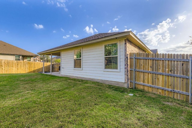 236 Cinnamon Loop, Burnet, TX 78611 - back of property featuring a fenced backyard and brick siding