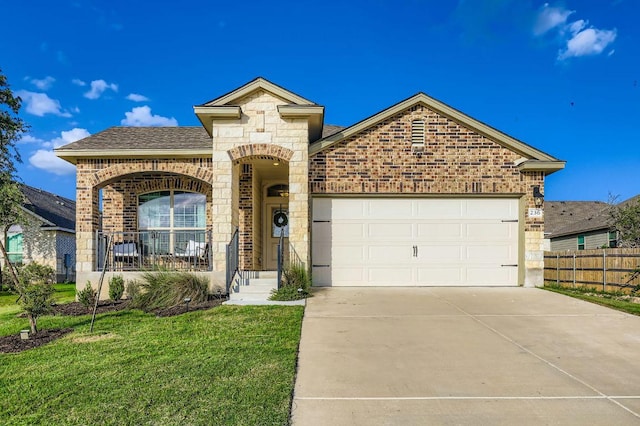 236 Cinnamon Loop, Burnet, TX 78611 - french country inspired facade with brick siding, a garage, concrete driveway, stone siding, and roof with shingles
